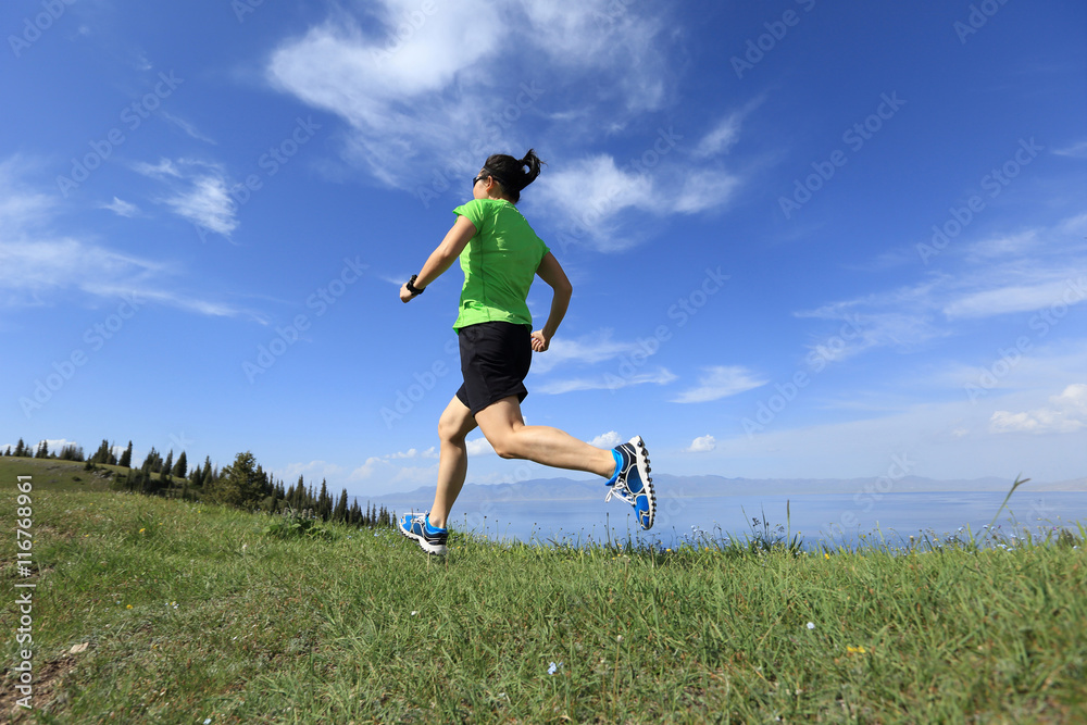 healthy young woman trail runner running on beautiful mountain peak healthy young woman trail runner running on beautiful mountain peak