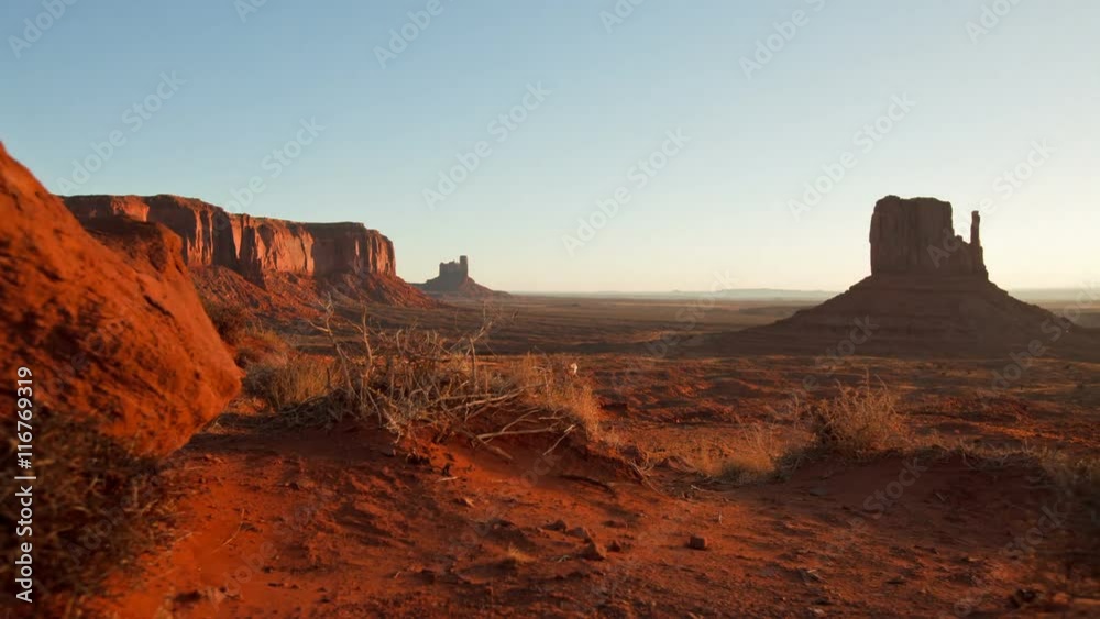Time Lapse of dawn at Monument Valley. Camera moves past tumbleweeds with the buttes of Monument Valley Arizona in the background. Time Lapse of dawn at Monument Valley. Camera moves past tumbleweeds with the buttes of Monument Valley Arizona in the background.