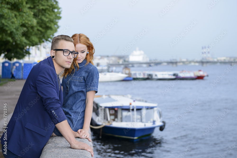 Love Story of young couple in St. Petersburg landmarks background