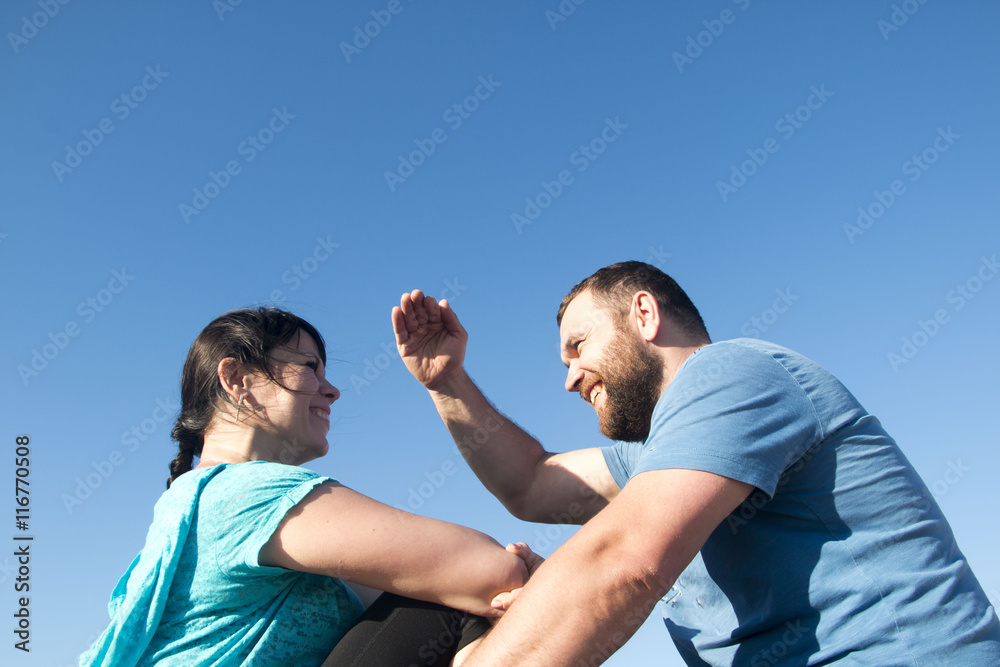 Fototapeta premium Brutal man and nice woman rest together outdoor