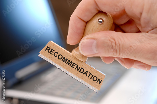 recommendation printed on rubber stamp in hand photo