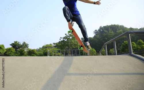young woman skateboarder skateboarding at skatepark