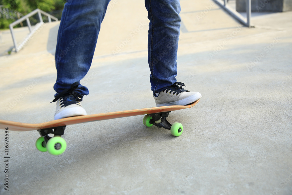 young woman skateboarder skateboarding at skatepark young woman skateboarder skateboarding at skatepark