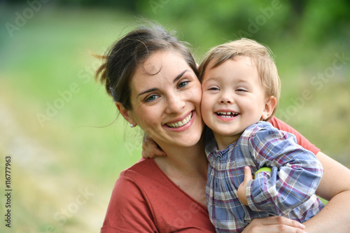 Mother and daugther cuddling in countryside photo
