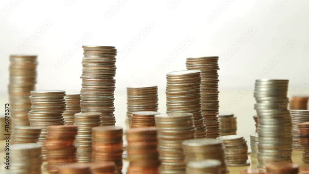 A city skyline made of stacked US coins. A city skyline made of stacked US coins.