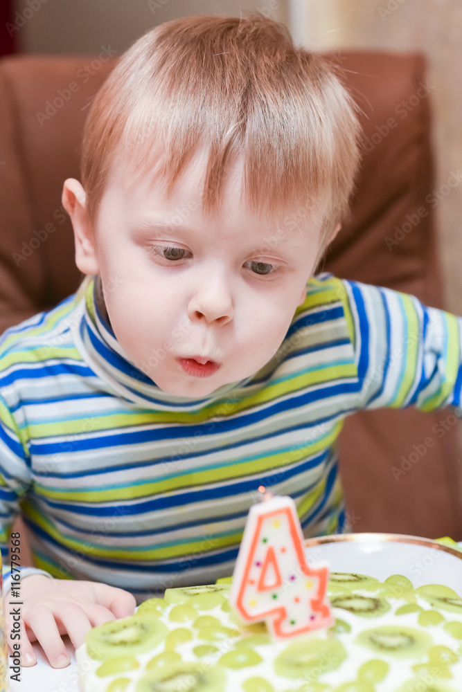 boy blows out the candles