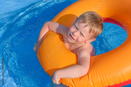 little boy on an inflatable circle in the water © dbrus