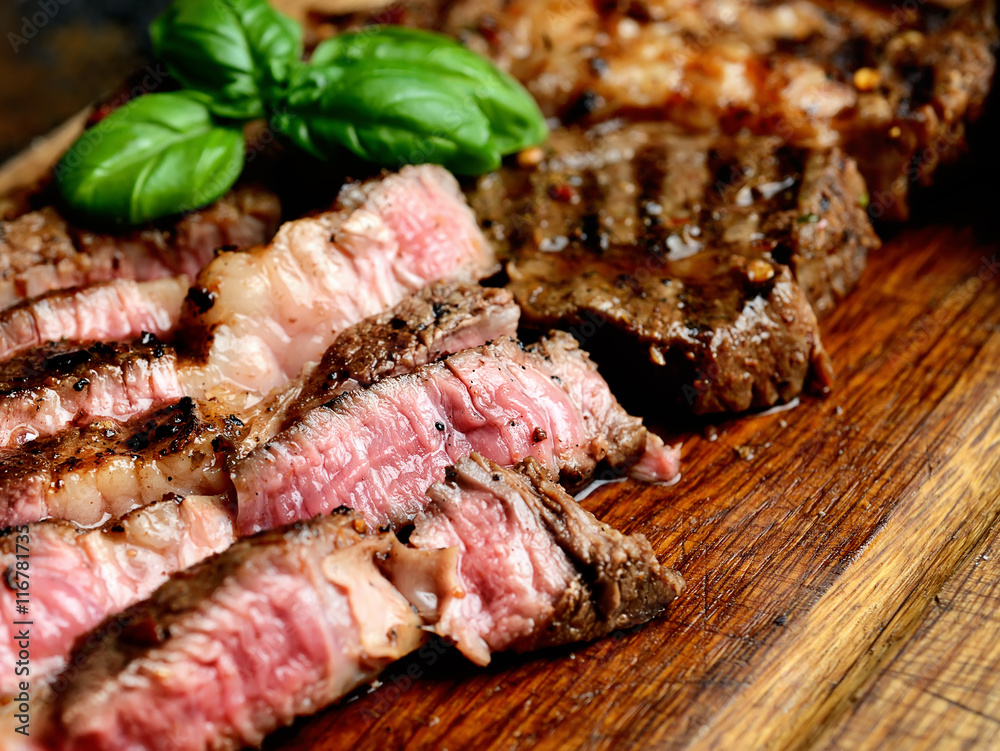 juicy grilled steaks on a cutting board juicy grilled steaks on a cutting board