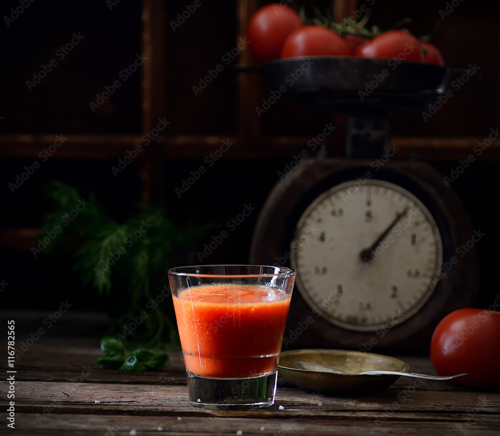 Fresh organic tomato juice on a wooden background Fresh organic tomato juice on a wooden background