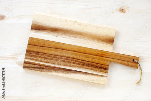 Empty wooden chopping board on table, background