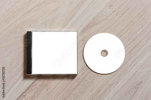 Compact disc template with plastic box with white isolated blank for branding design. CD jewel case mock up with clean free space with booklet for print on wooden table. Top view