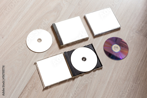 Full set compact disc template with plastic box case with white isolated blank for branding design and open box with booklet and back side. CD jewel case mock up with clean free space on wooden table.