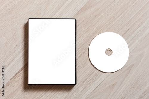 Dvd or cd disc cover case mockup. Template with plastic box and disc with white isolated free space for design. Mock up with black package for compact or dvd disc. On wooden table background photo