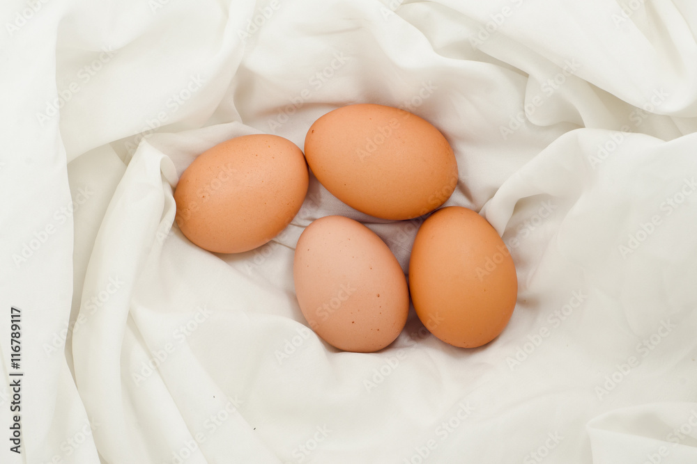 Eggs on fabric White.Chicken eggs on white fabric.easter eggs on fabric with copy space. Eggs on fabric White.Chicken eggs on white fabric.easter eggs on fabric with copy space.