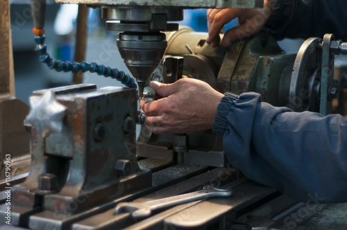 The worker at the metalworking machine