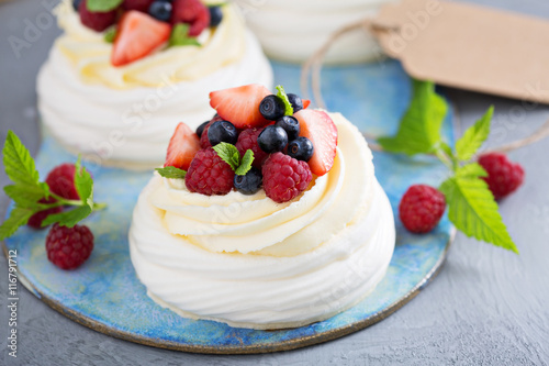 Pavlova cakes with cream and fresh berries photo