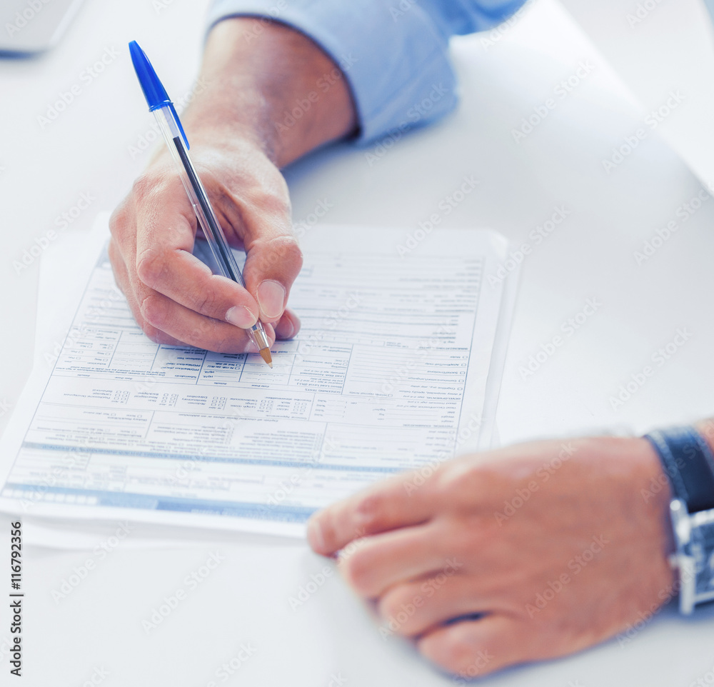 man filling tax form man filling tax form