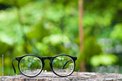 Eyeglasses on wooden table.