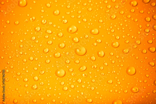Drops of water on a color background. Orange. Shallow depth of f