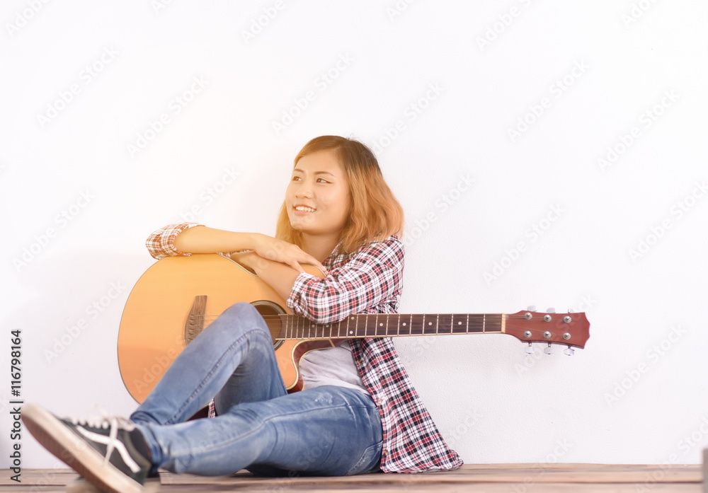 Fototapeta premium Woman play with guitar at home