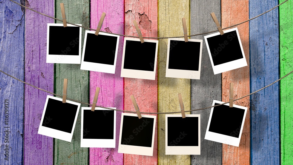 lots blank instant photos hanging on the clothesline 