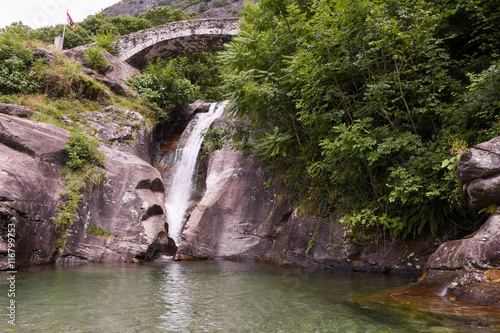 Santa Petronilla waterfalls with roman bridge in Biasca