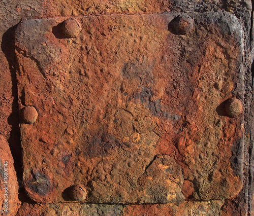 Rusty, brown metal sign with rivets. Detail of a shipwreck at the beach of in Beira, Mozambique, Southern Africa