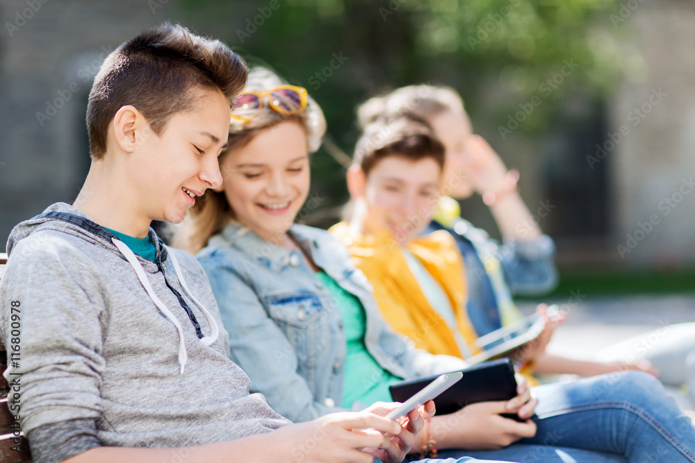 happy teenage friends with tablet pc outdoors happy teenage friends with tablet pc outdoors