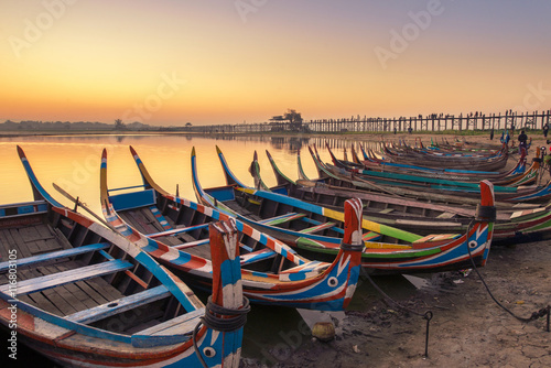 sunrise in the morning at ubein bridge with a boat photo