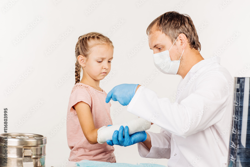 doctor bandaging hand of little patient. medicine doctor bandaging hand of little patient. medicine