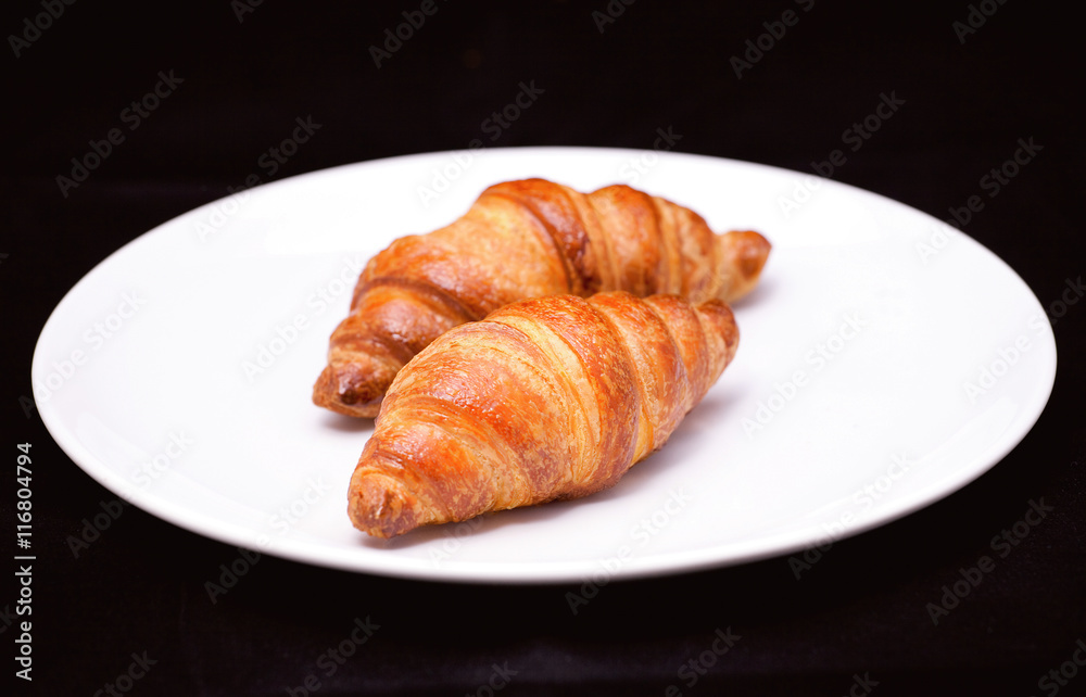 Two croissants on white plate Two croissants on white plate