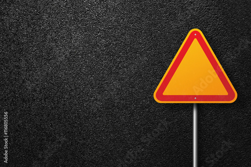 Road signs of the triangular shape on a background of asphalt. The texture of the tarmac, top view.