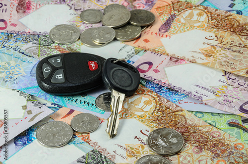 Qatar currency with car key photo