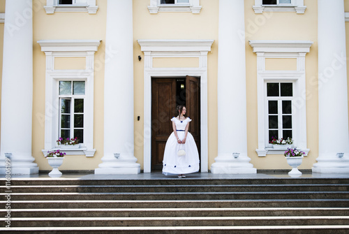 Fototapeta Girl in ancient dress with crinoline on the background of the building with colu