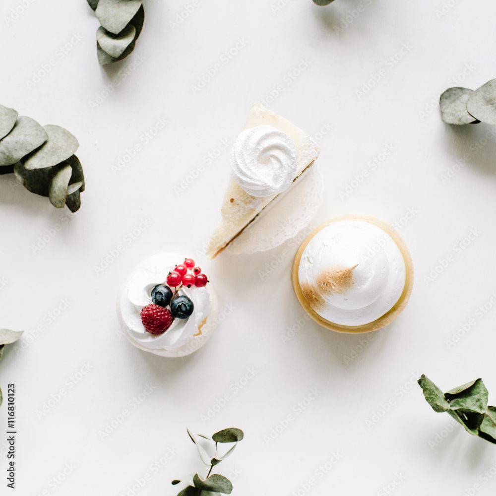Breakfast composition with cakes and eucalyptus branches on with background. Flat lay, top view Breakfast composition with cakes and eucalyptus branches on with background. Flat lay, top view