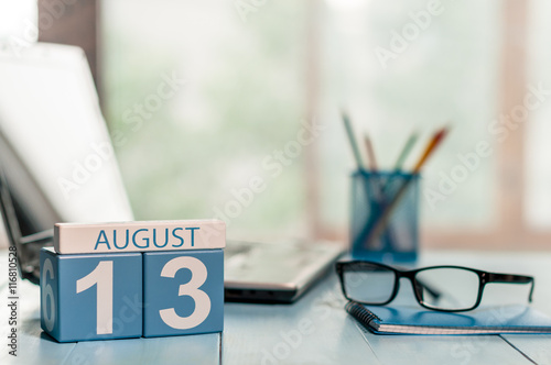 August 13th. Day 13 of month, wooden color calendar on business background. Summer time. Empty space for text
