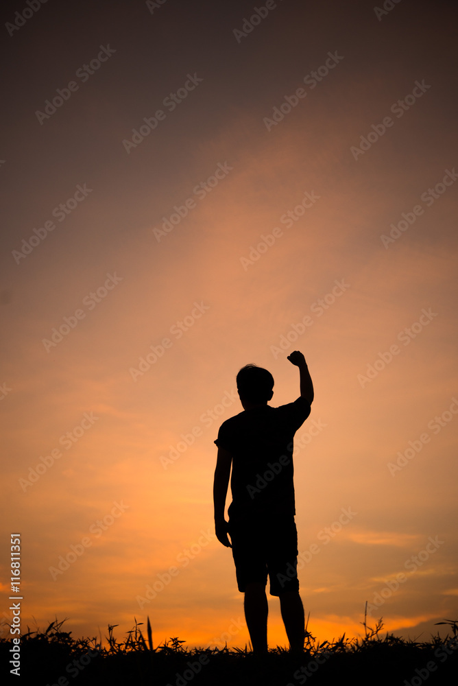 Silhouette of man and beautiful sky. hand up of success.