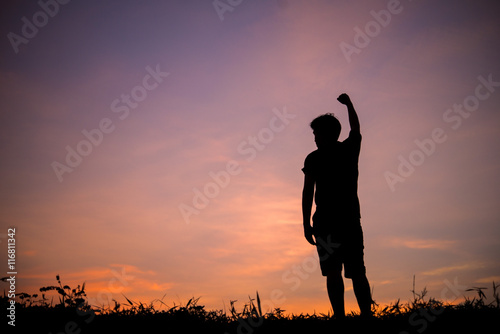 Silhouette of man and beautiful sky. hand up of success.