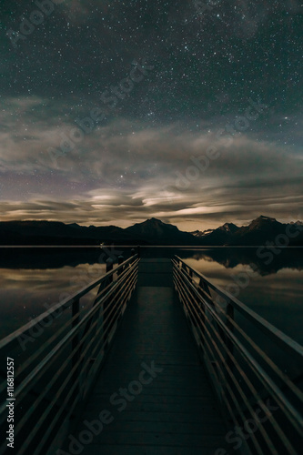 Starry sky over pier on Lake Mcdonald, Glacier National Park, Montana