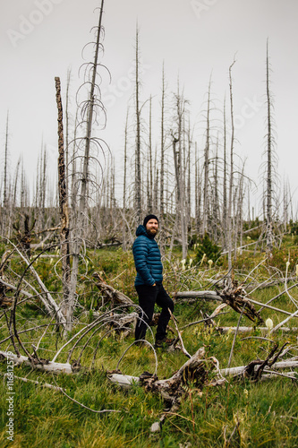 Man in forest looking at camera, Glacier National Park, Montana