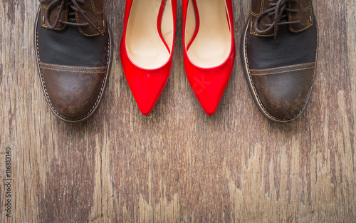 Top view, flat lay background of brown leather shoes and red high heel shoes
