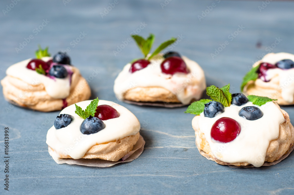 Pavlova dessert with blueberries cherries and mint

