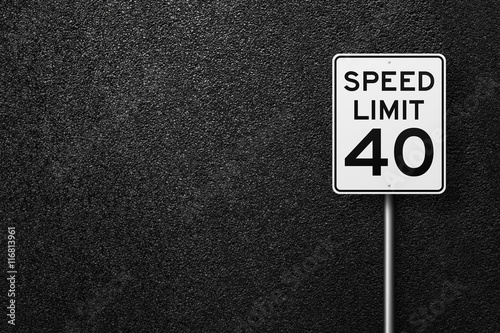 Road sign on a background of asphalt. Speed limit. The texture of the tarmac, top view.