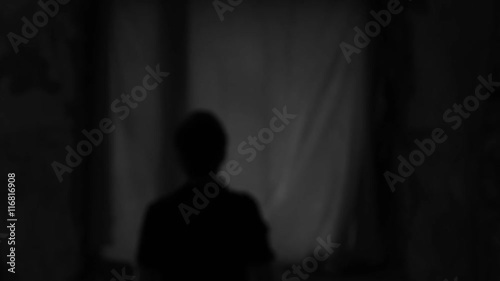 a man stands in front of the moon
