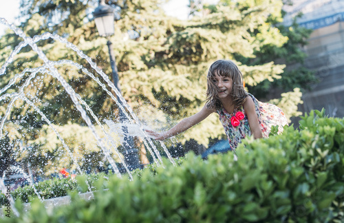 happy child playing in a fountain