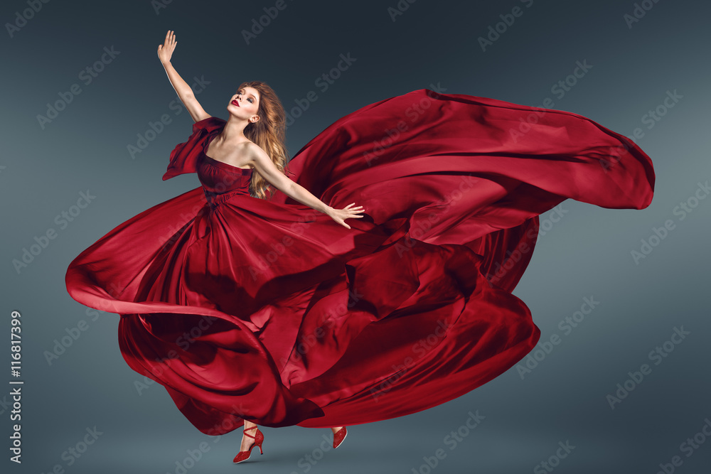 Fashion woman dancing in fluttering red dress Fashion woman dancing in fluttering red dress