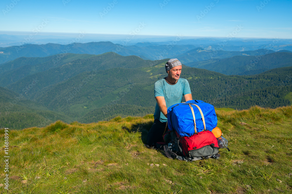 Hiker sitting on a mountain pass