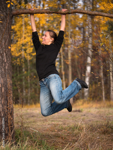 Adult woman hanging on a branch drawn in feet