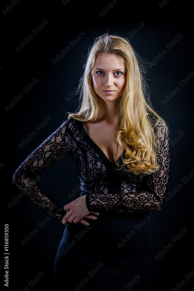 blonde girl on a black background in a dark guipure dress blonde girl on a black background in a dark guipure dress