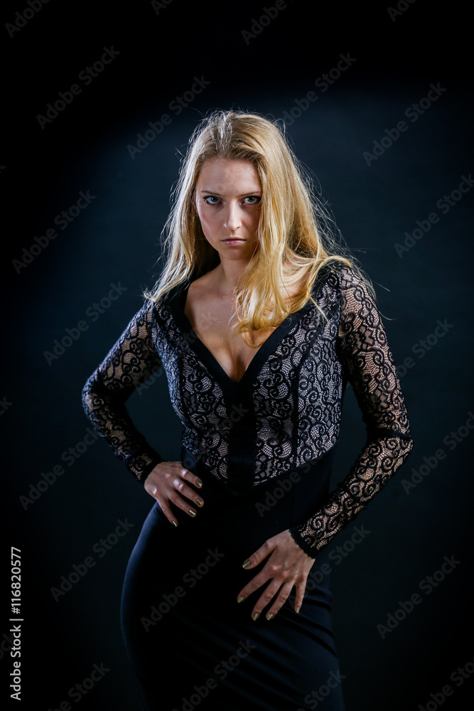 blonde girl on a black background in a dark guipure dress blonde girl on a black background in a dark guipure dress
